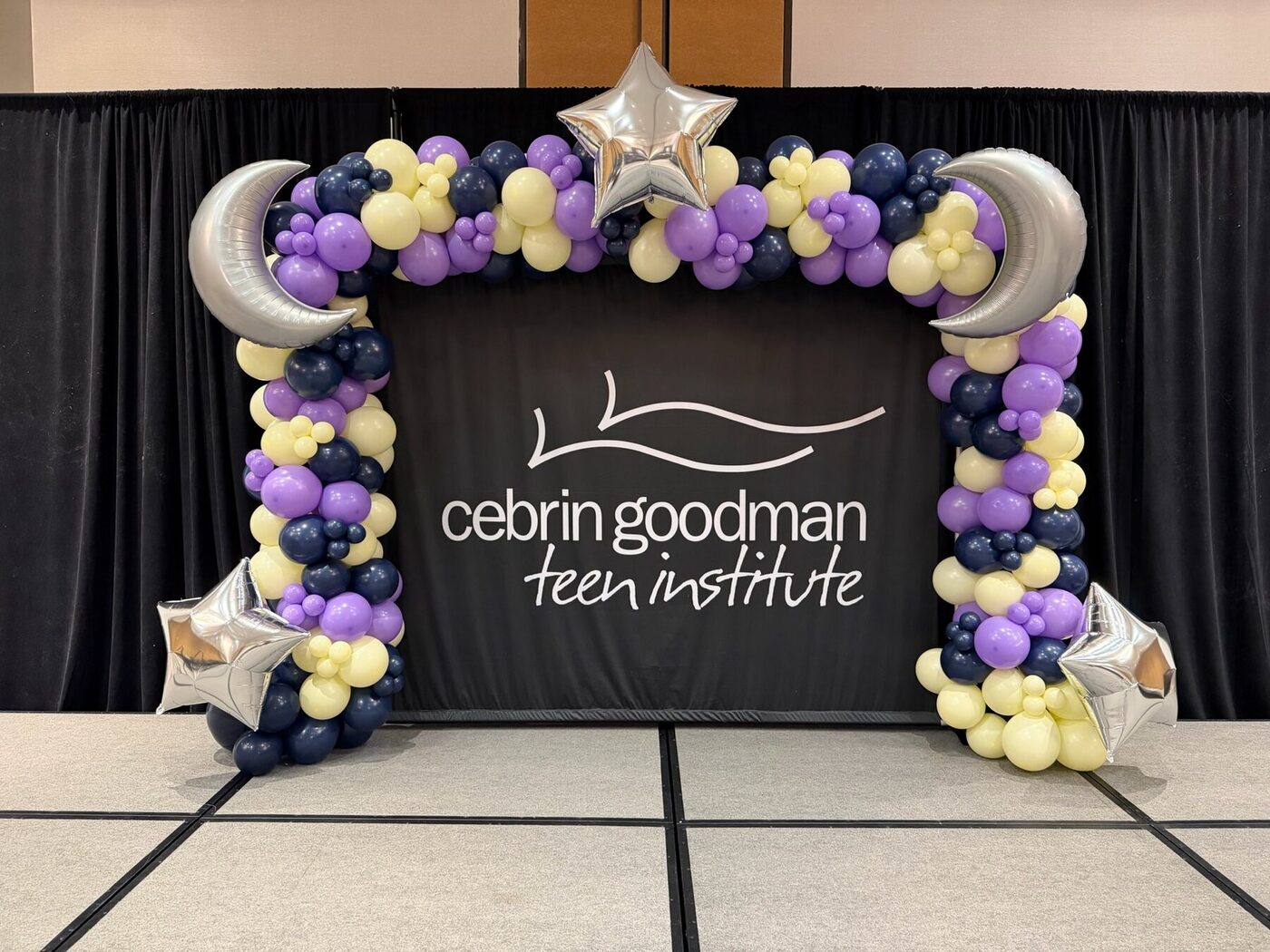 Purple, navy, and cream organic stage garland with moon and star accents